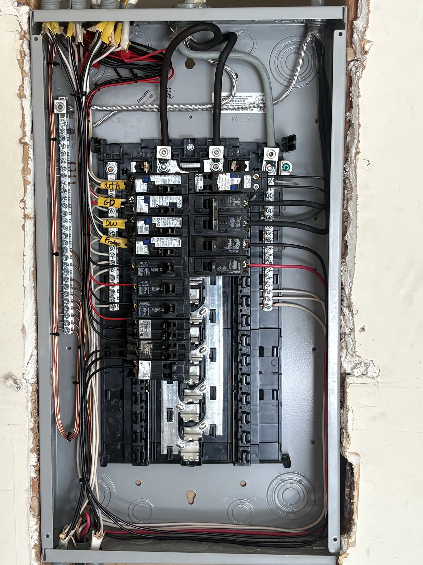 Open residential breaker panel showing neat wiring